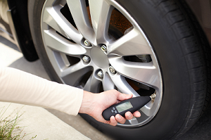 Checking Tire Pressure with Pressure Gage 